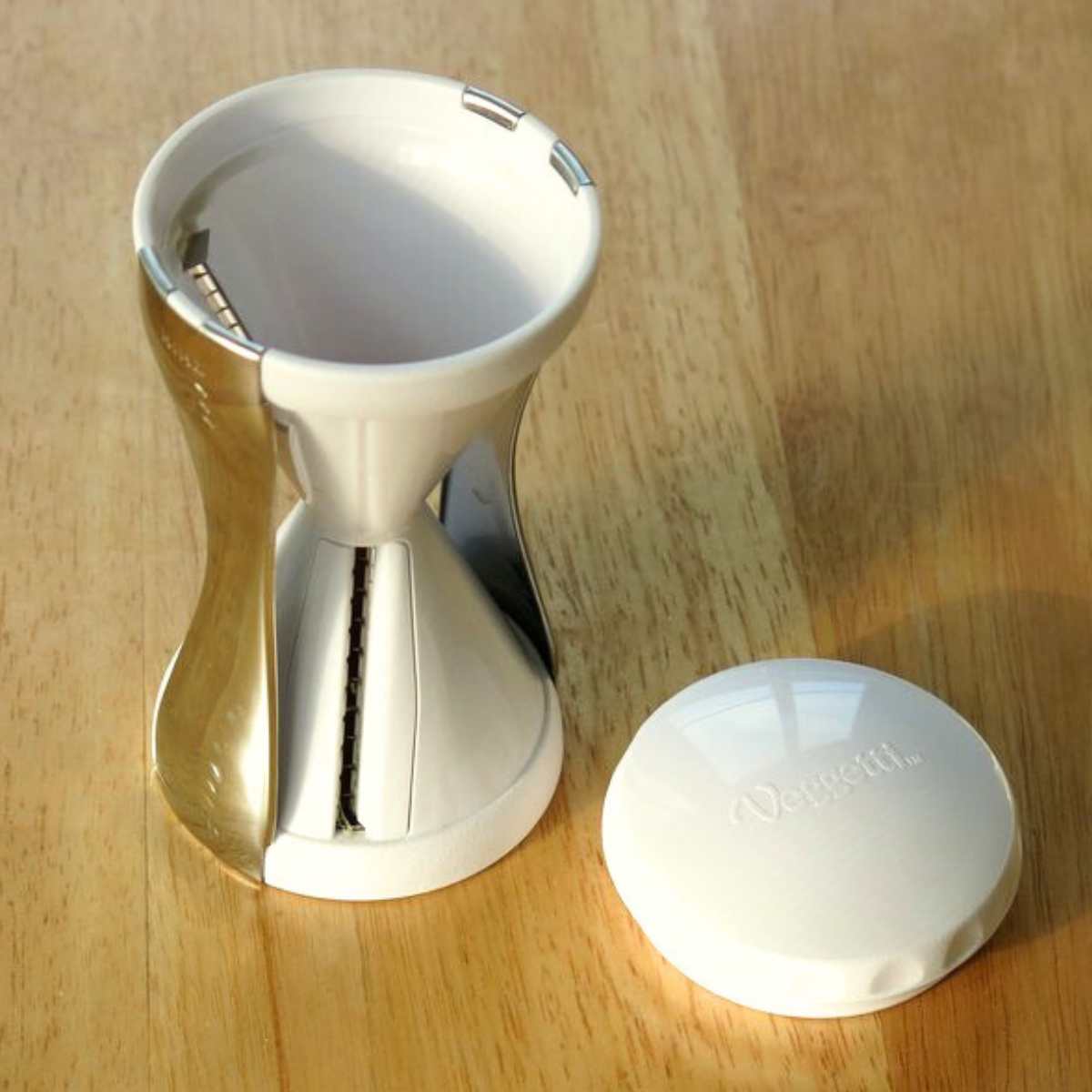 Veggetti spiralizer with the top off on a cutting board.