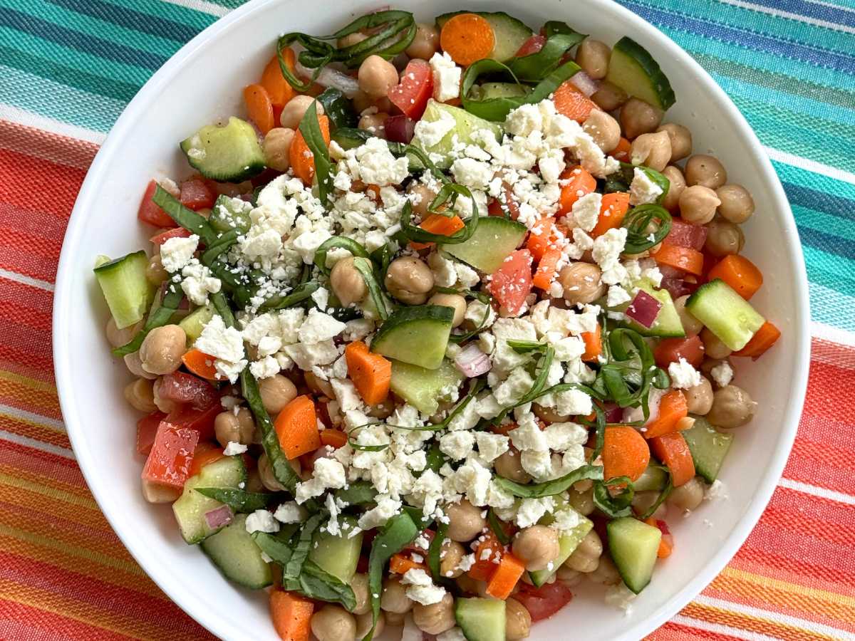 Chickpea cucumber feta salad in a white bowl.