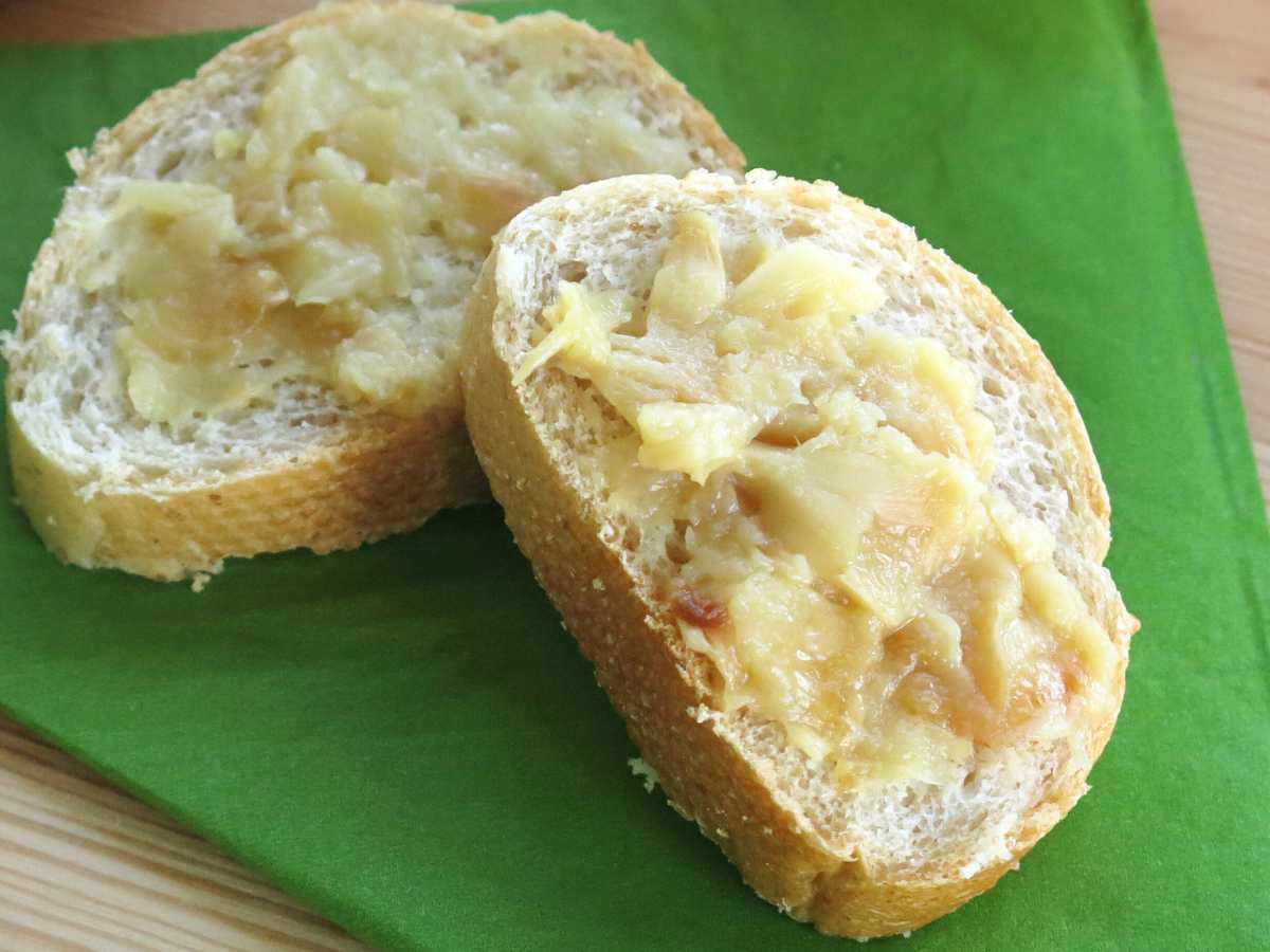 Roasted garlic spread on two pieces of bread.