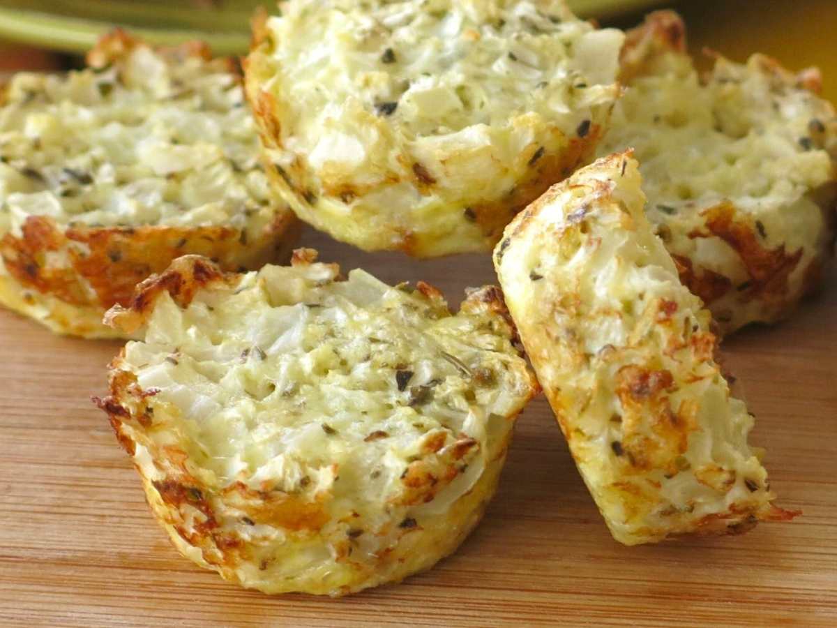 Mini cauliflower muffins on a cutting board.