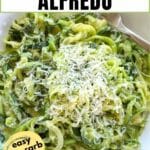 Zucchini noodle Alfredo in a white bowl topped with extra Parmesan cheese with text overlay with name and note that says easy, low-carb, recipe.