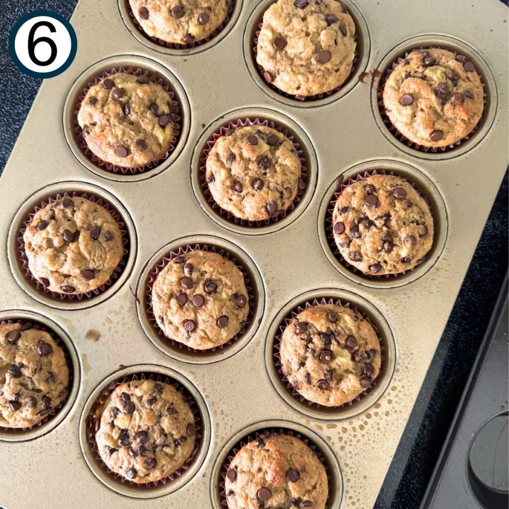 Twelve cooked banana yogurt muffins in a muffin pan.
