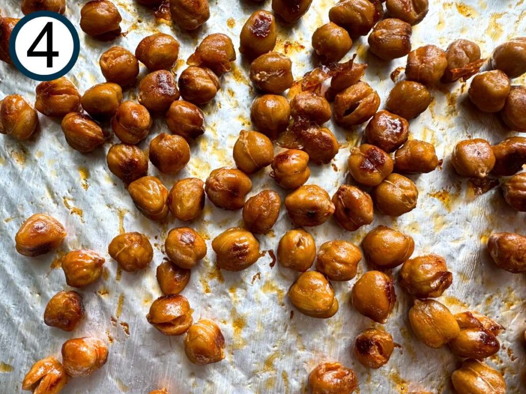 Roasted buffalo chickpeas on a sheet pan.