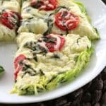Slices of crustless zucchini pie made with spiralized zucchini noodles on a white plate.