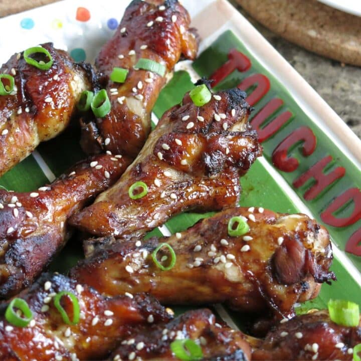 Sticky baked chicken wings made with molasses, honey, and garlic, on a platter.