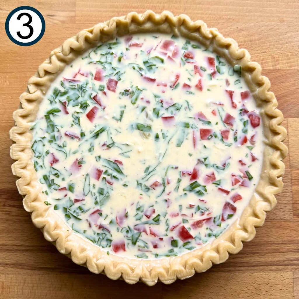 Tomato bacon quiche filling in a pie crust.
