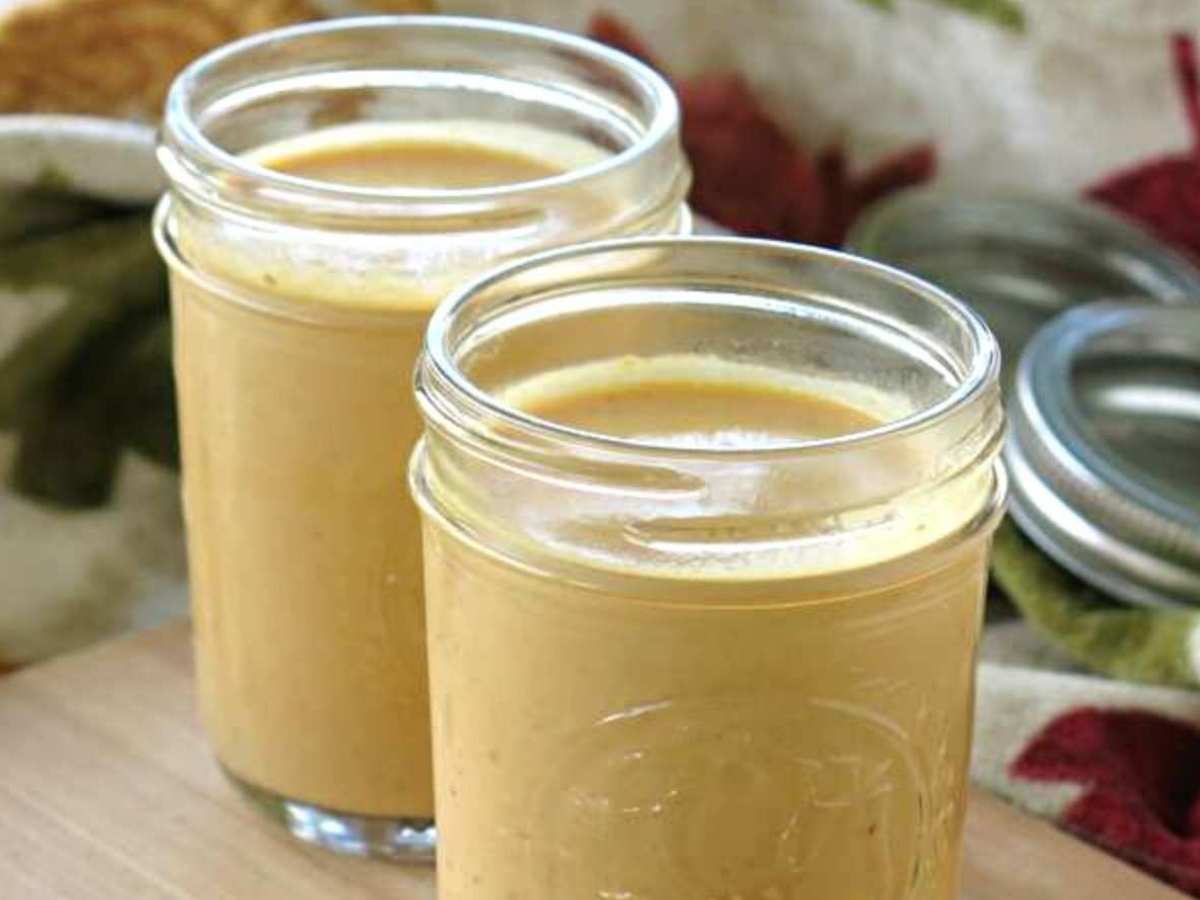Two mason jars with pumpkin pasta sauce.