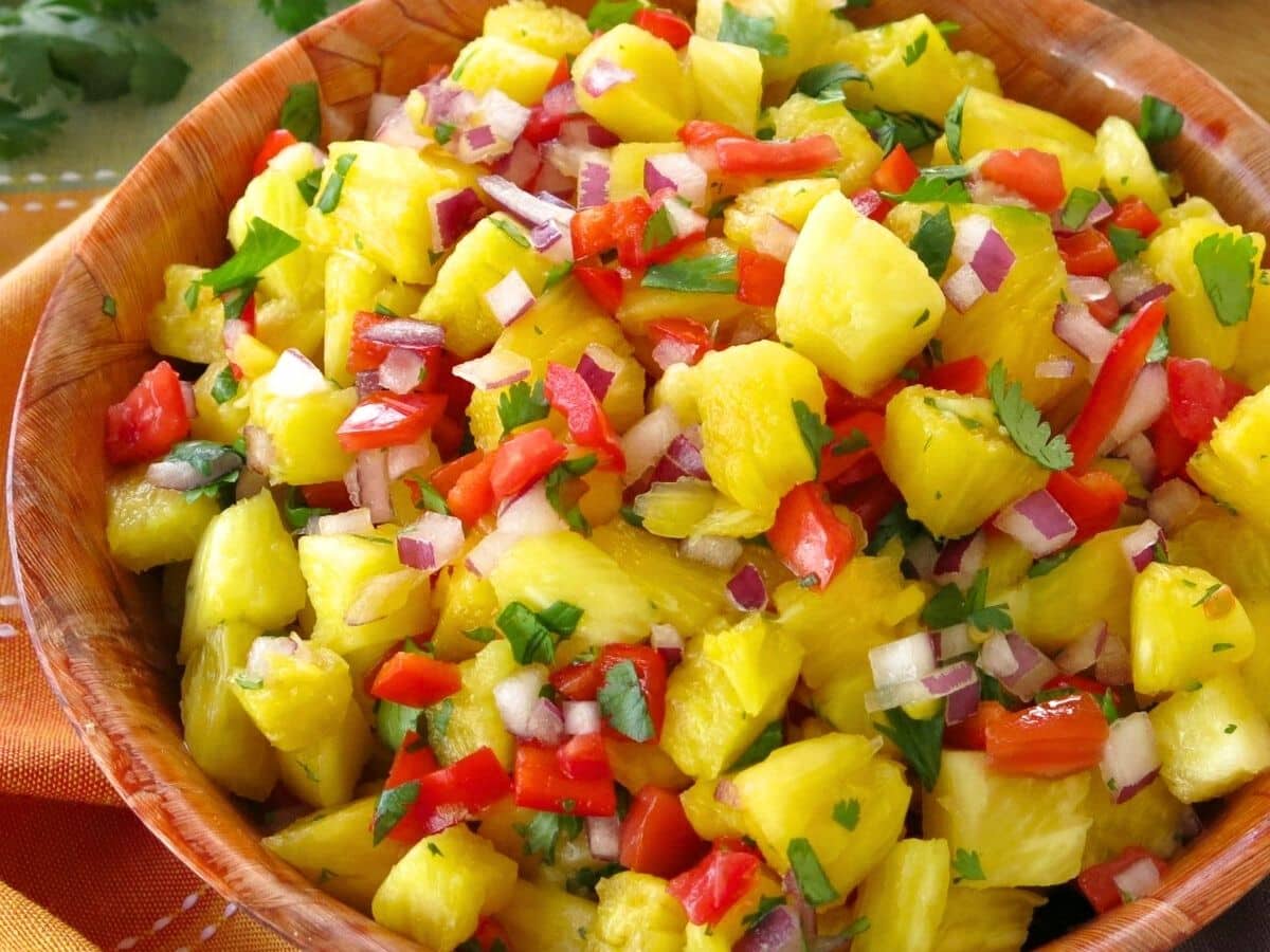 Pineapple salsa in a brown bowl.