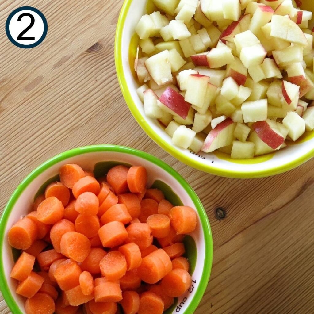 Chopped apple in a bowl and diced carrot in a bowl.