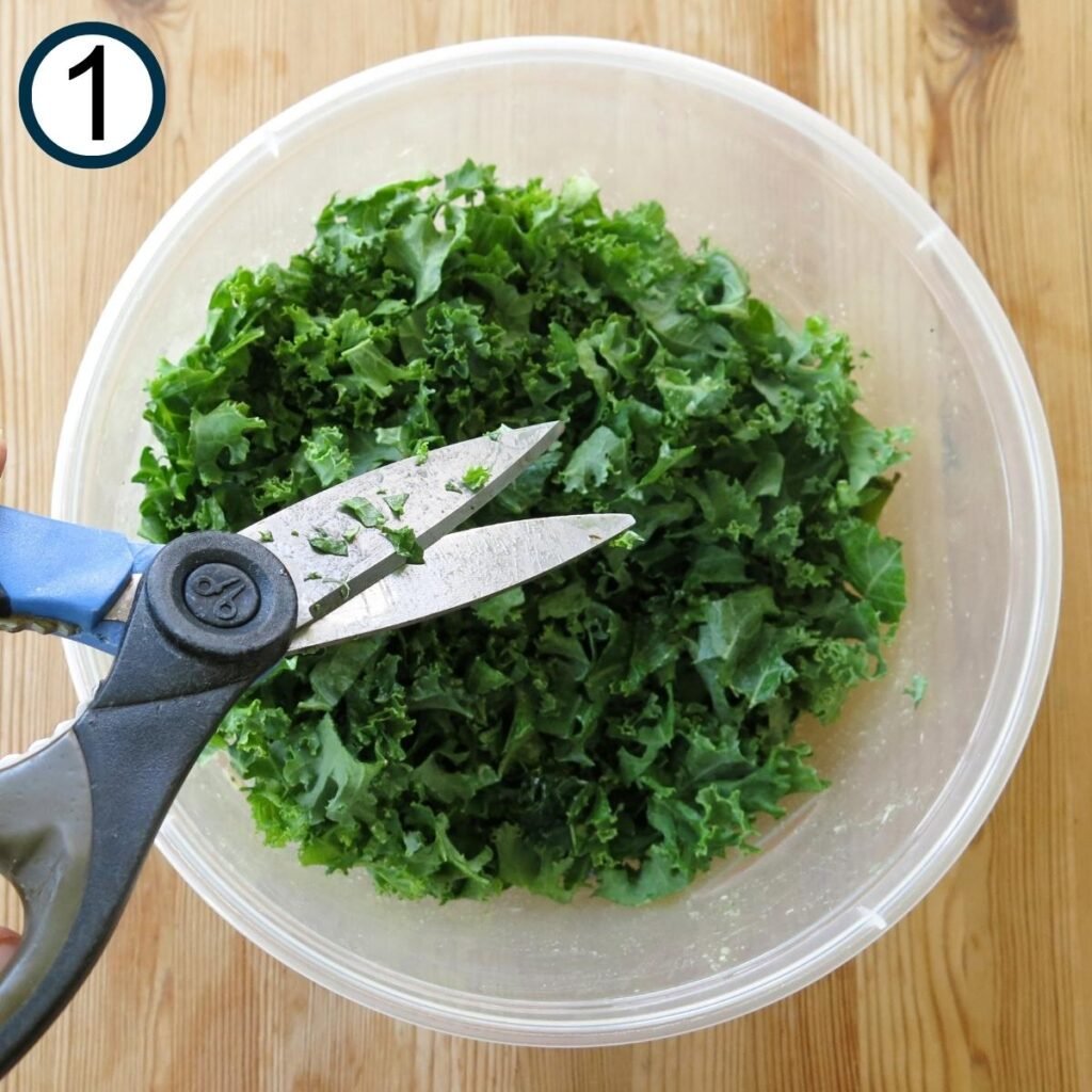 Chopped kale in a bowl with scissors snipping. 