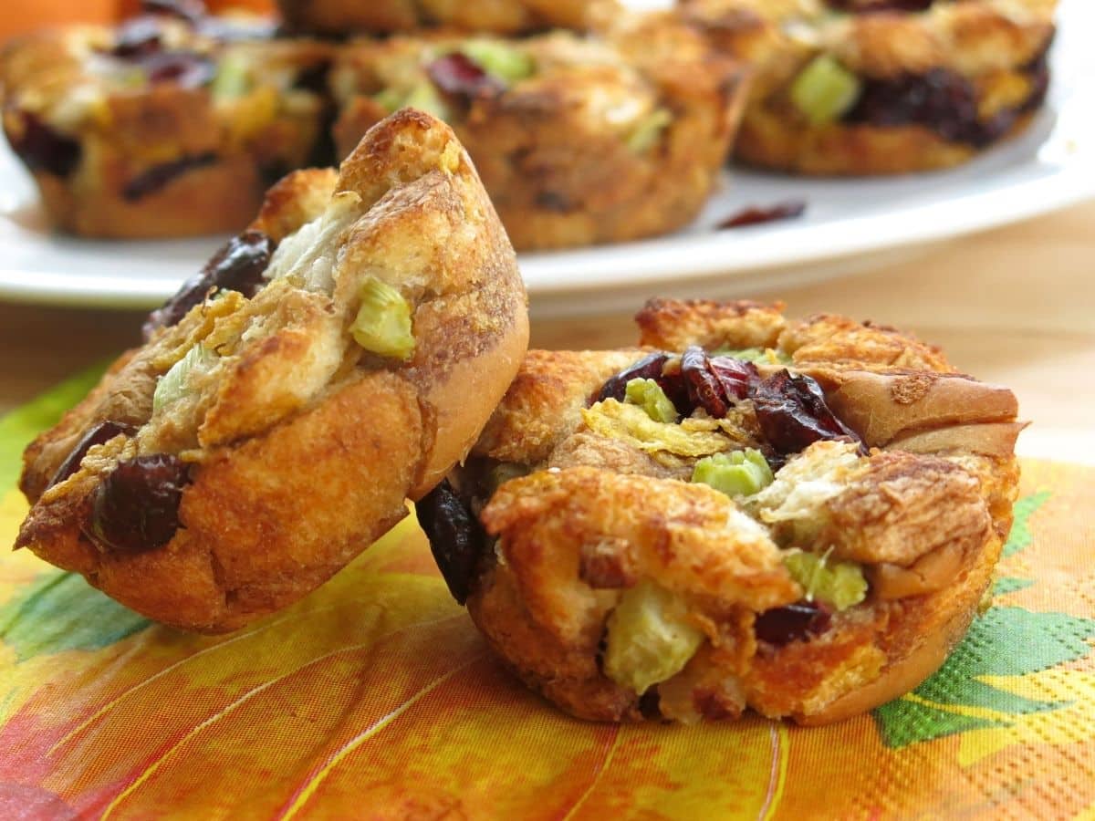 Two muffin tin stuffing cups on a fall napkin.
