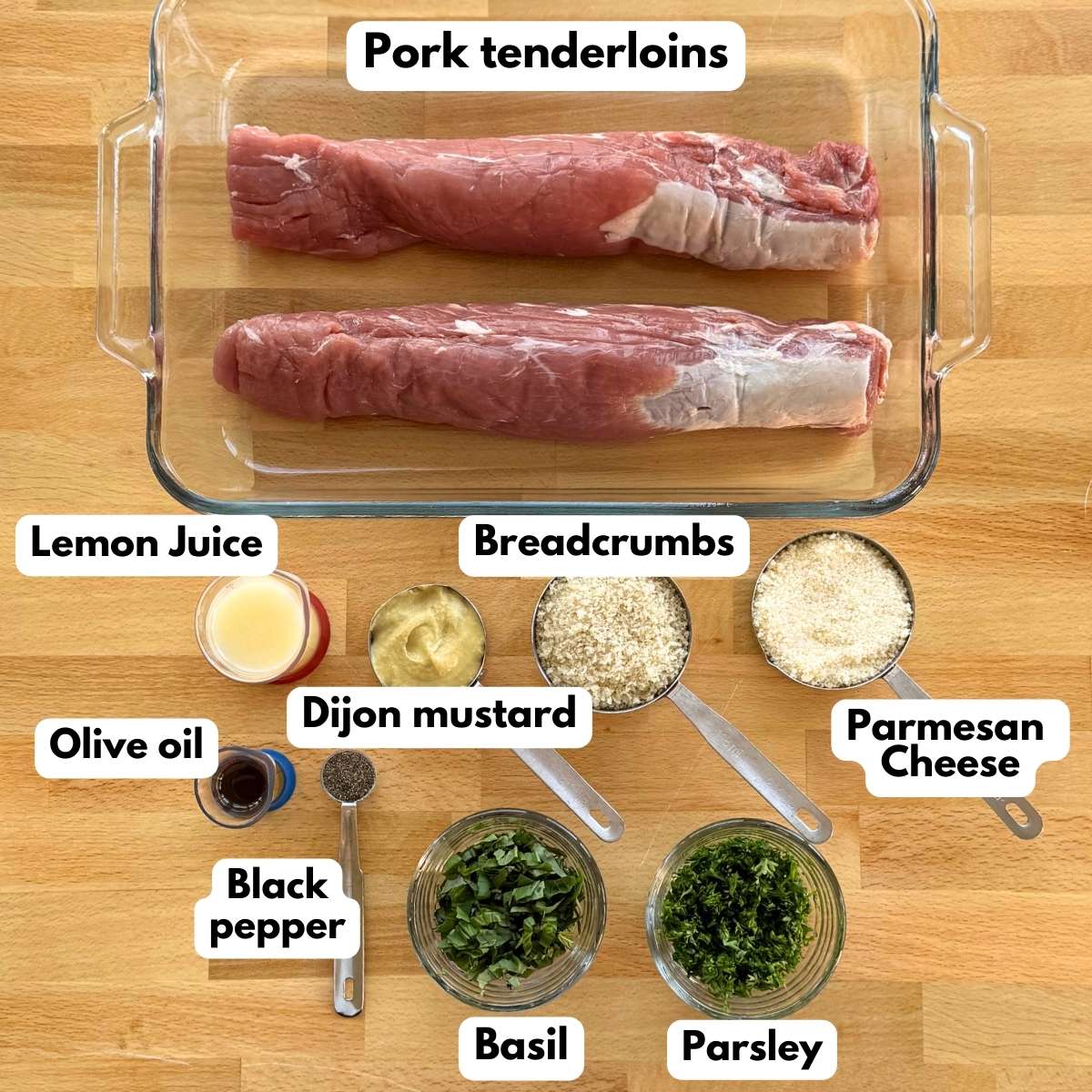 Ingredients needed to make herb crusted pork tenderloin: 2 pork tenderloins, lemon juice, Dijon mustard, breadcrumbs, Parmesan cheese, olive oil, black pepper, fresh chopped basil and parsley.