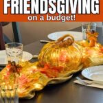 Friendsgiving tablescape with fall leaves, a pumpkin, white plates, and glasses.