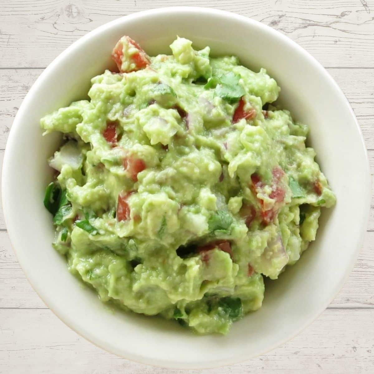 Guacamole in a white bowl.