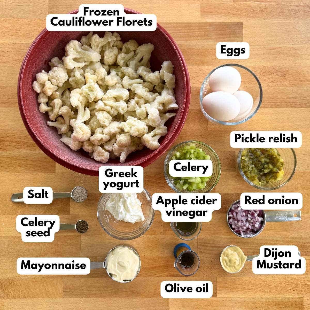 Collage of ingredients to make roasted cauliflower potato salad: frozen cauliflower florets, eggs, pickle relish, celery, red onion, greek yogurt, mayonnaise, Dijon mustard, apple cider vinegar, celery salt, salt and olive oil.