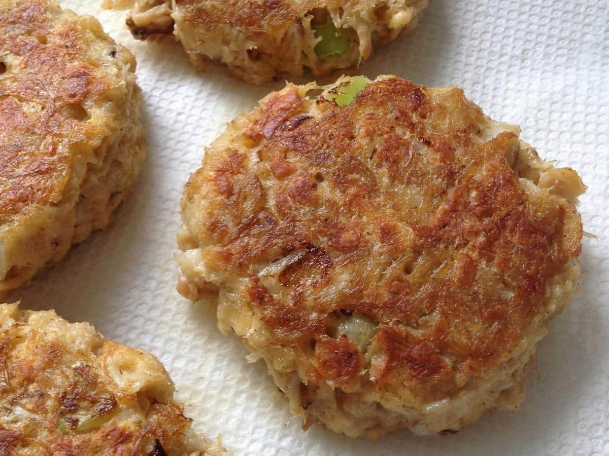 Cooked crab cakes on paper towels.