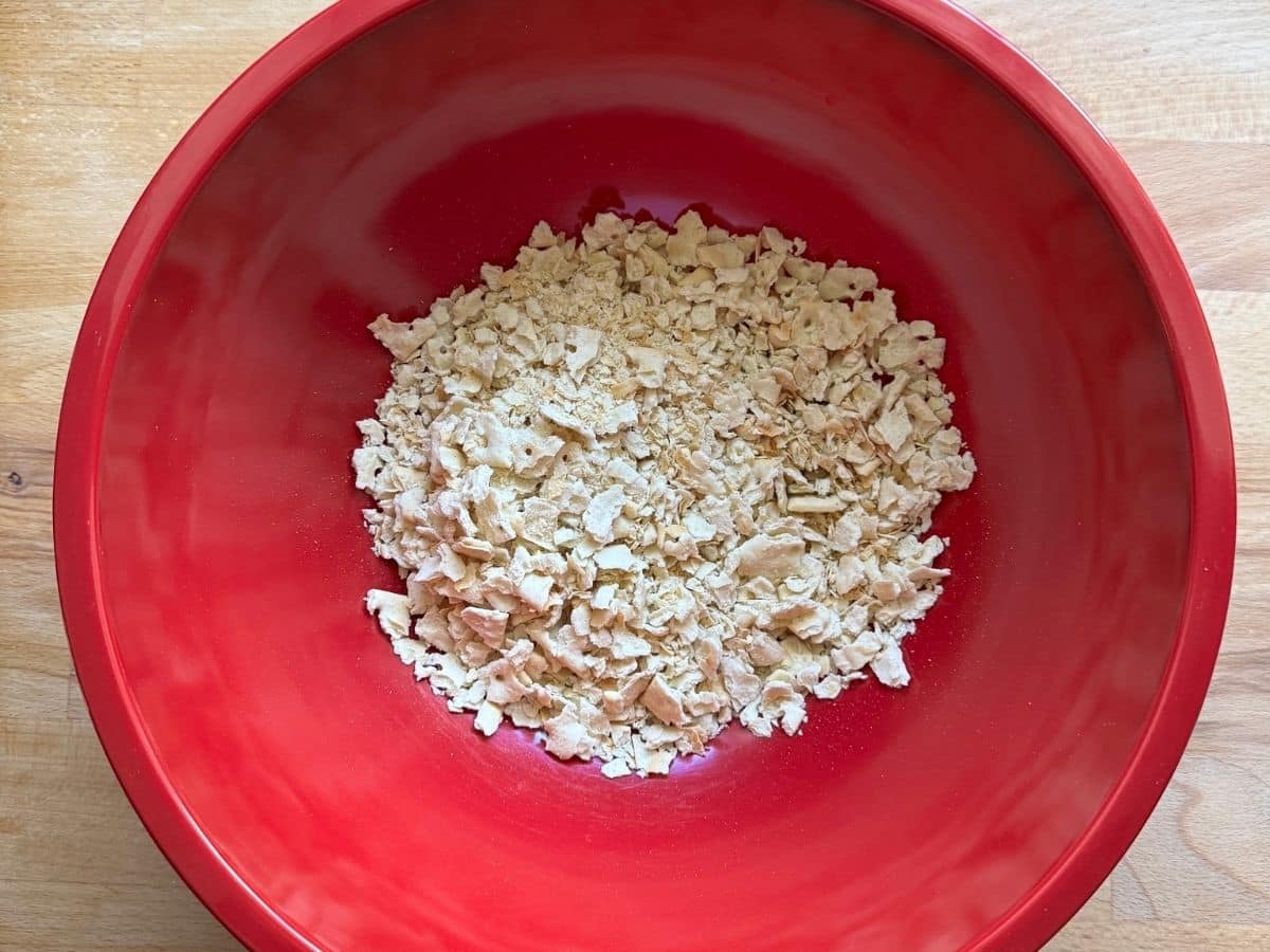 Crushed saltines in a red bowl.