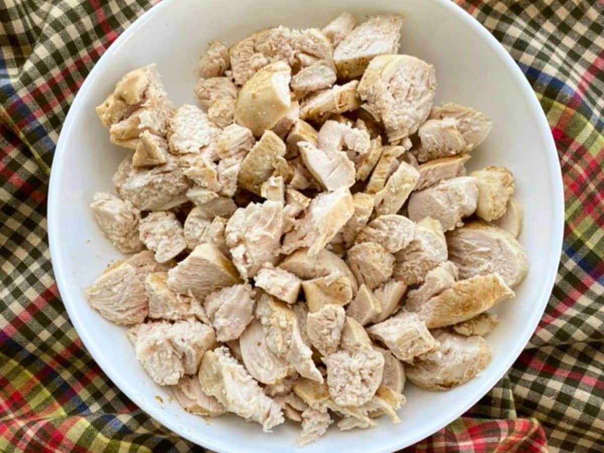 Diced cooked chicken on a white plate.
