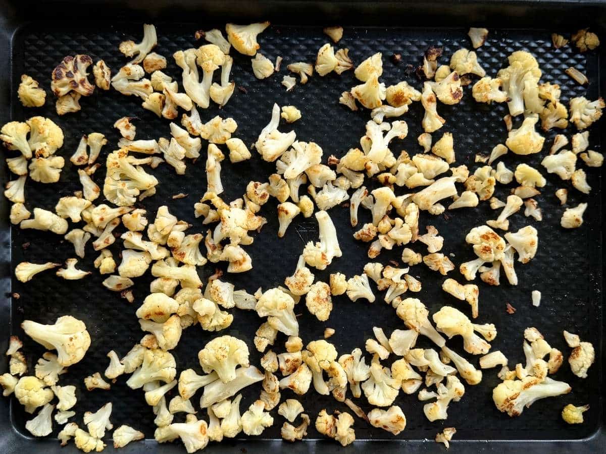 Roasted cauliflower on a large sheet pan.