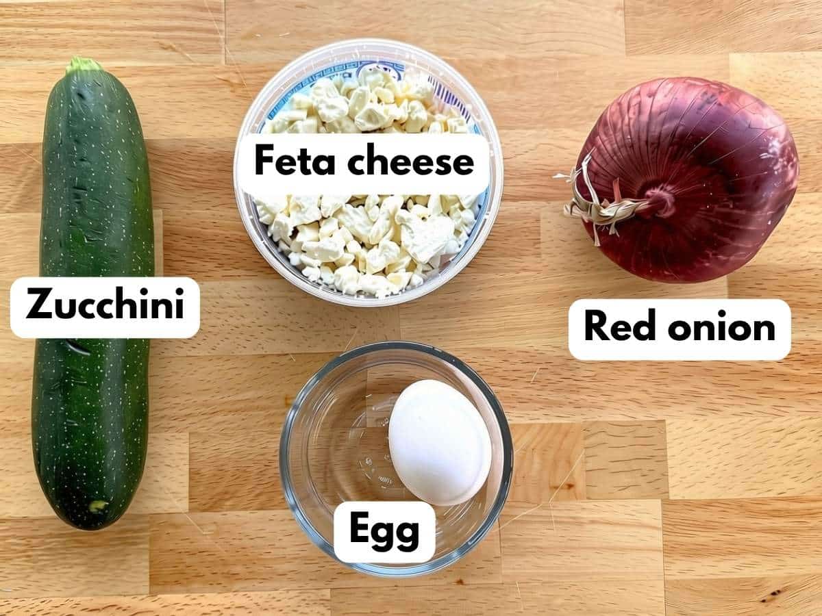 Labeled ingredients: zucchini, feta cheese, red onion, and egg.