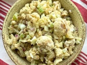 Roasted cauliflower potato salad from frozen cauliflower with a Greek yogurt dressing in a light brown bowl.