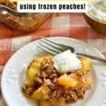 Serving of peach crisp made with frozen peaches and an almond flour and oat topping on a white plate.