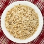 Roasted cauliflower rice made with frozen riced cauliflower, garlic and Parmesan cheese in a white bowl.