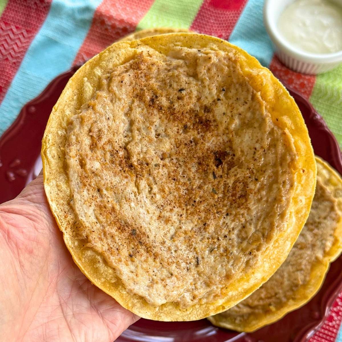 Baked ground chicken taco with browned seasoned chicken pressed onto a crispy corn tortilla.