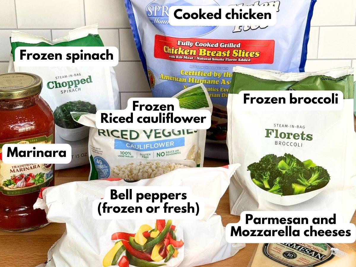 Ingredients for chicken marinara meal prep bowls with frozen vegetables, cauliflower rice, cooked chicken, marinara and cheese.