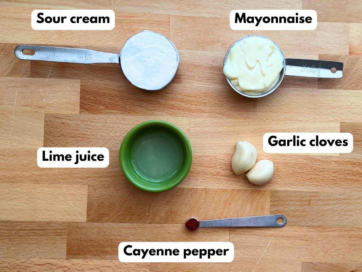 Lime crema ingredients including sour cream, mayonnaise, lime juice, fresh garlic, and cayenne pepper.
