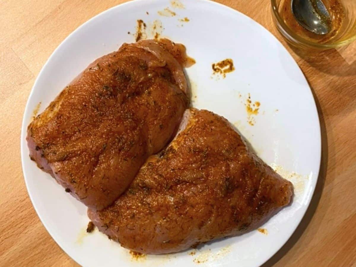 Two turkey tenderloin rubbed with a paste of seasonings and olive oil.