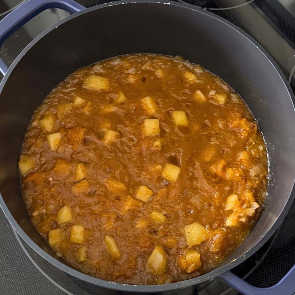 Butternut squash puree and broth simmering in a large pot.
