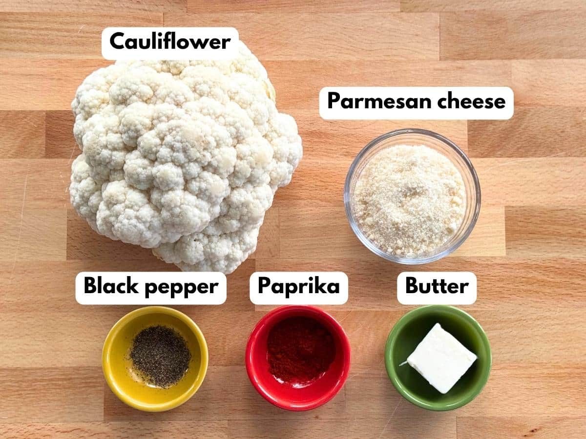 Labeled ingredients for Parmesan cauliflower bites: cauliflower, Parmesan cheese, butter, paprika, and black pepper.