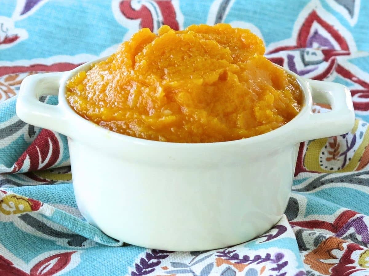 A cream crock with pureed butternut squash.
