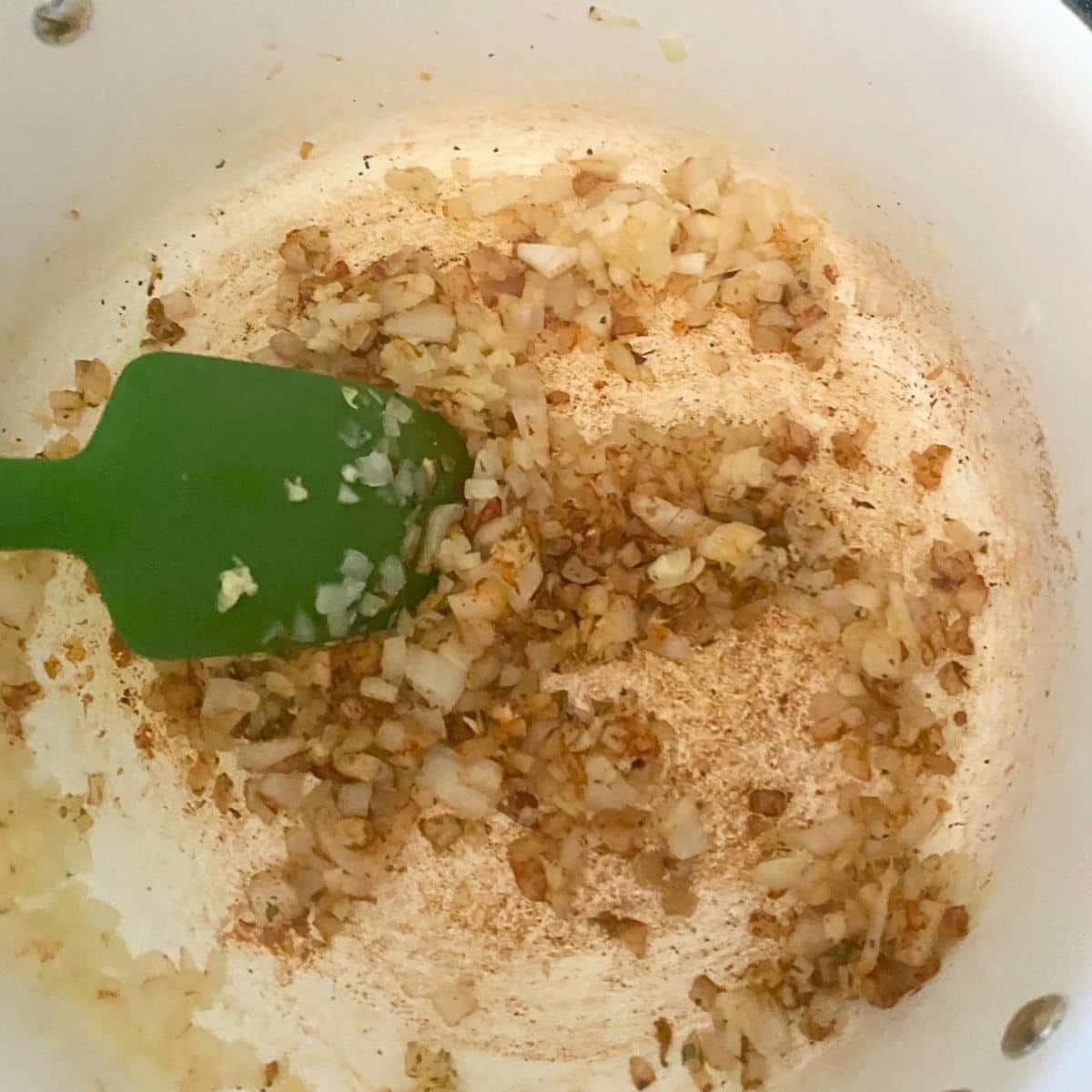 Sautéed onions, garlic, and spices in a Dutch oven for white chicken chili.