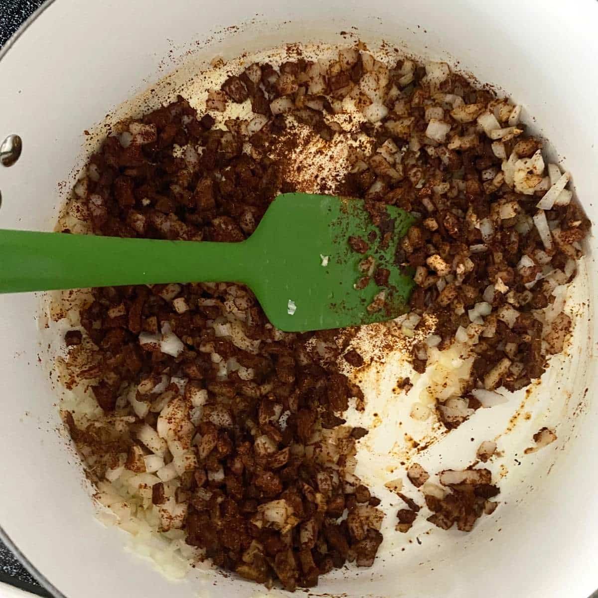 Chili powder and cumin cooking with onion and garlic for Southern chili.