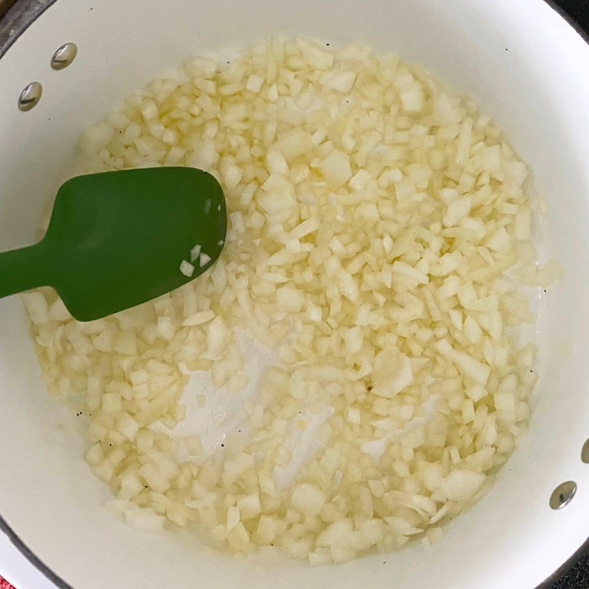 Diced onion sautéing in a pot for Southern chili.