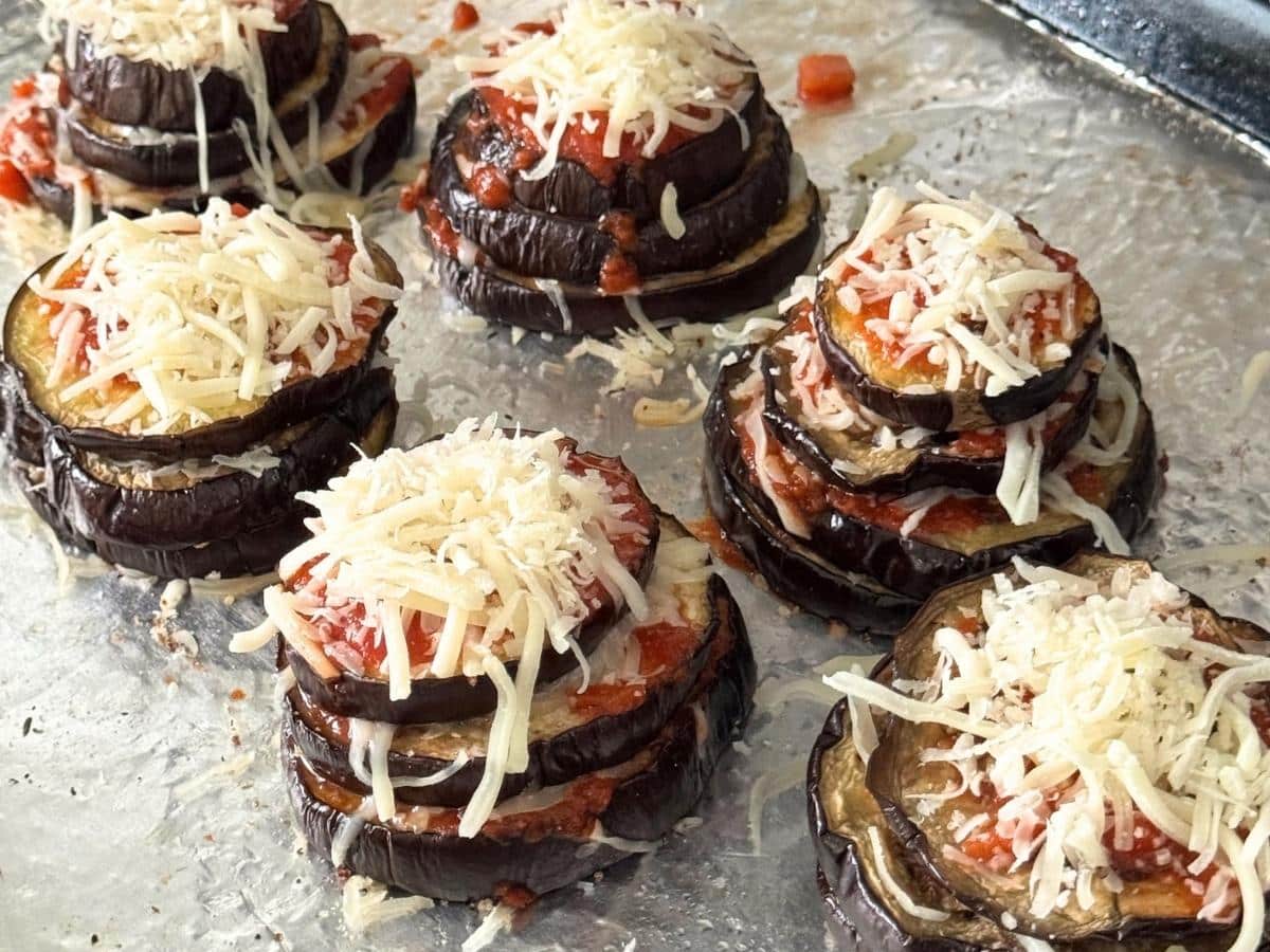 Eggplant Parmesan stacks layered with marinara, mozzarella, and Parmesan before baking.